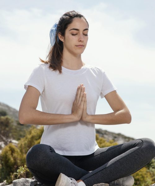 young-woman-meditating-outdoors